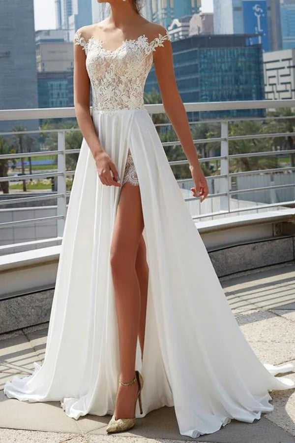 Close-up of the off-shoulder neckline and sheer bodice of the A-line wedding dress.