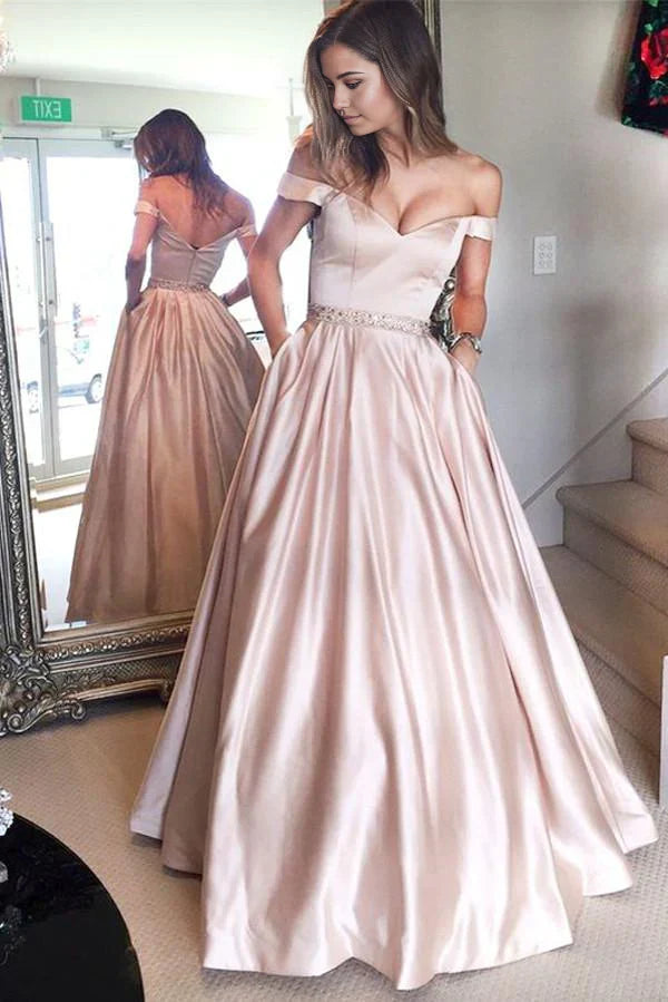 Woman wearing an elegant A-line off-the-shoulder floor-length prom dress.
