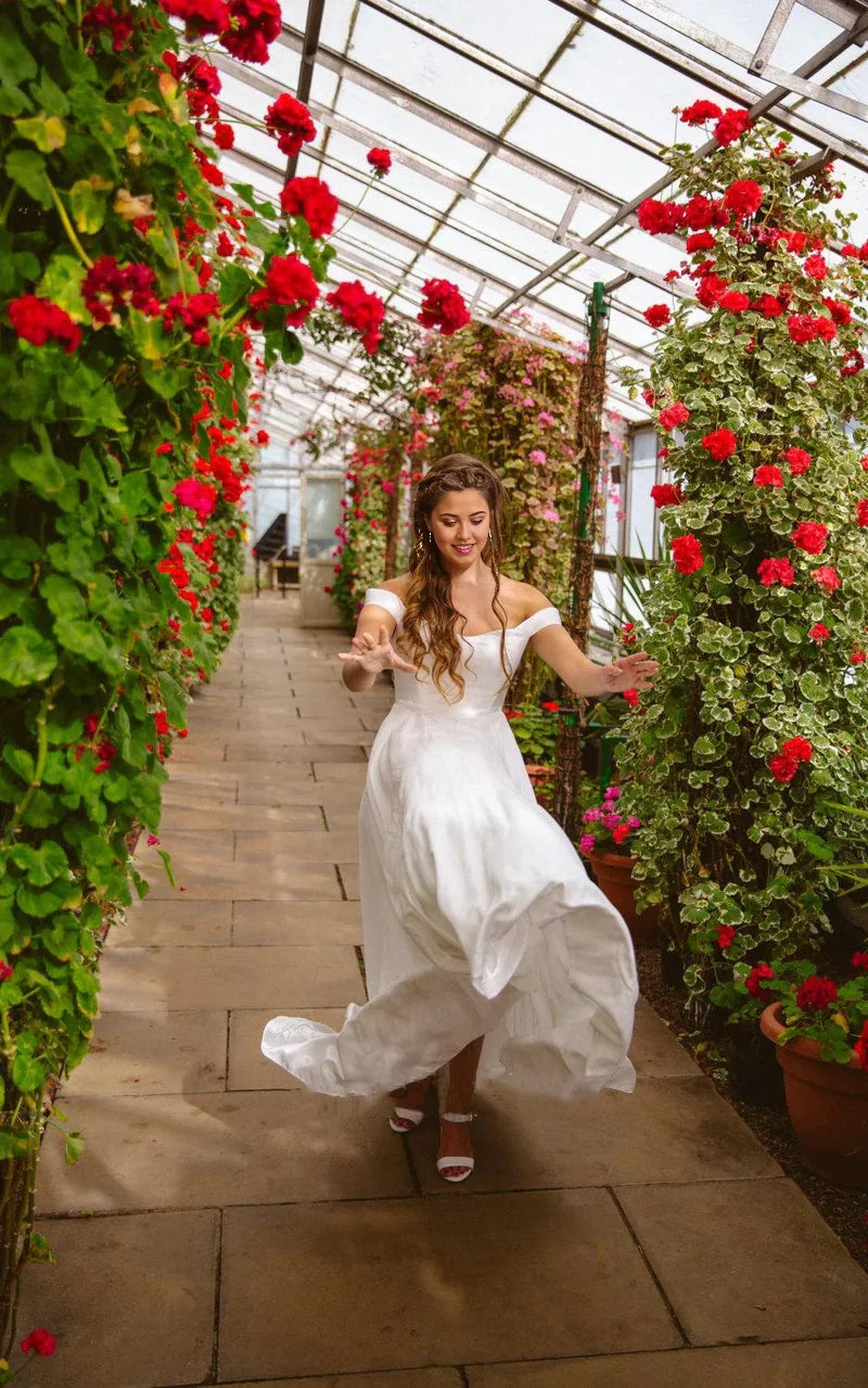 Elegant A-line off-shoulder satin wedding dress.