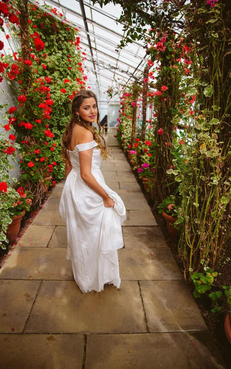 Model wearing a simple A-line satin bridal gown.