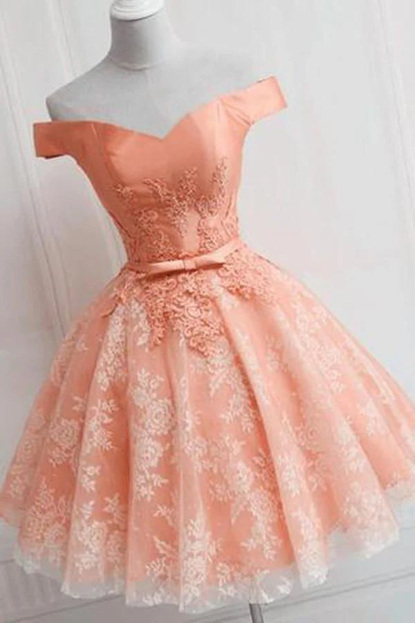 Model wearing a short A-line off-shoulder party dress with delicate appliques.