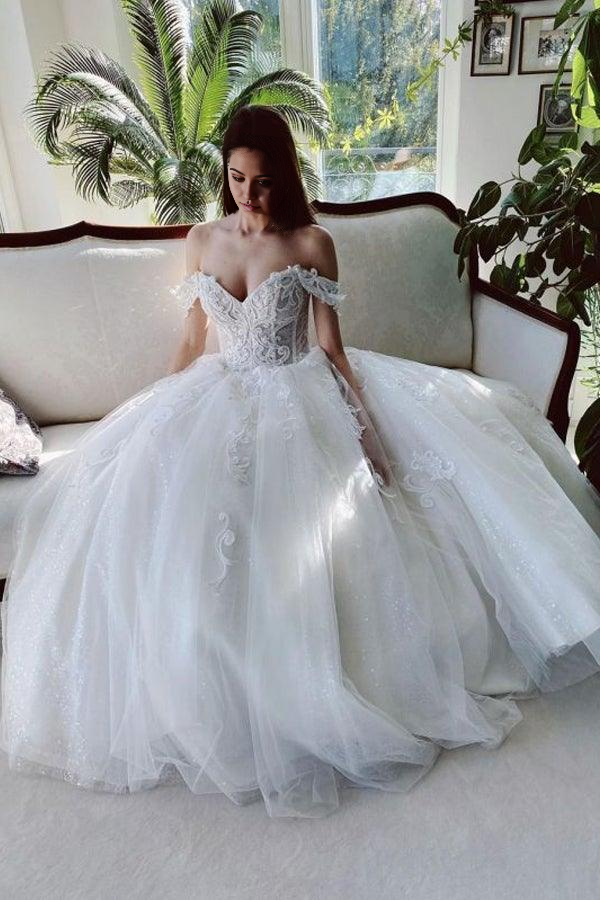 Elegant A-line off-shoulder white wedding dress with tulle, appliques, and beading.