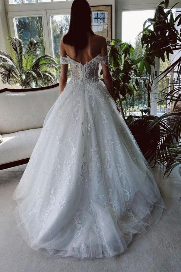 Back view of a white A-line wedding dress featuring off-shoulder design and intricate beading.