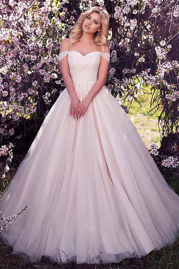 Elegant A-line off-shoulder wedding dress with intricate beading and tulle details.