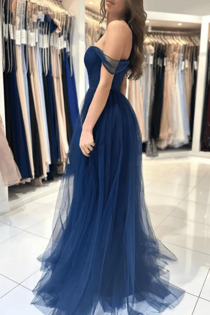 Close-up of the flowing tulle skirt and off-shoulder neckline of a prom dress.