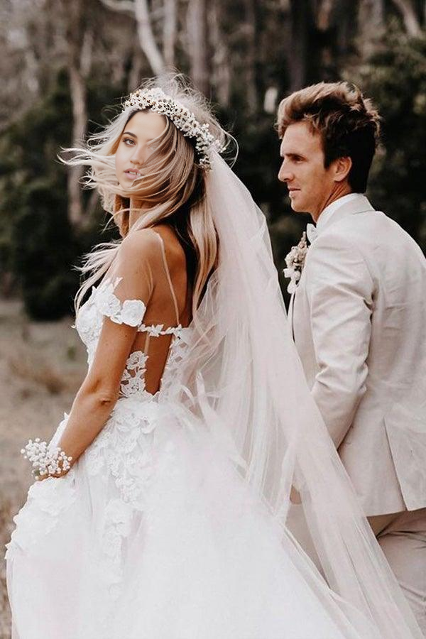 Side view of the white tulle ball gown wedding dress with off-shoulder design.