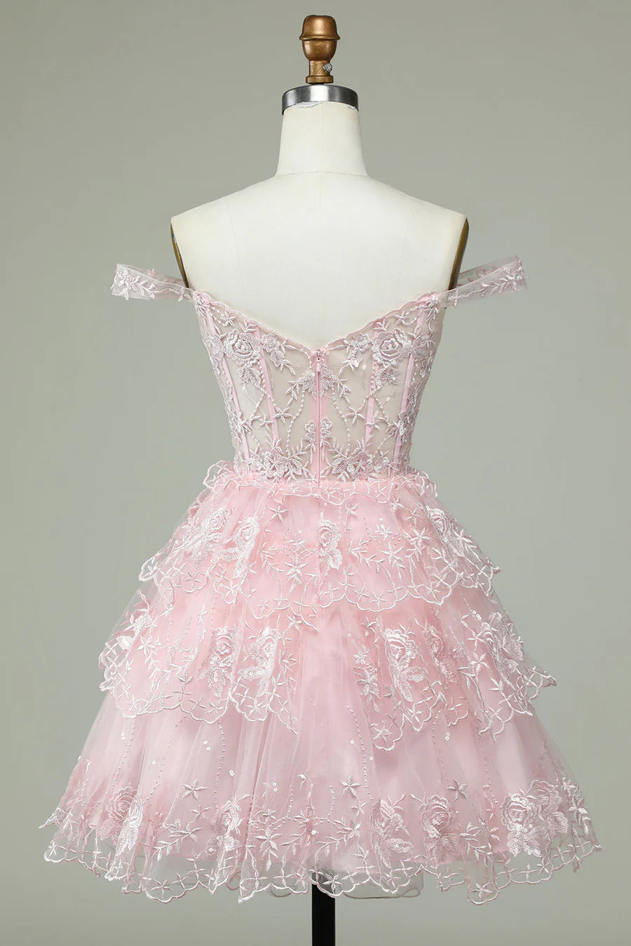 Back view of blush pink multi-layered homecoming dress.
