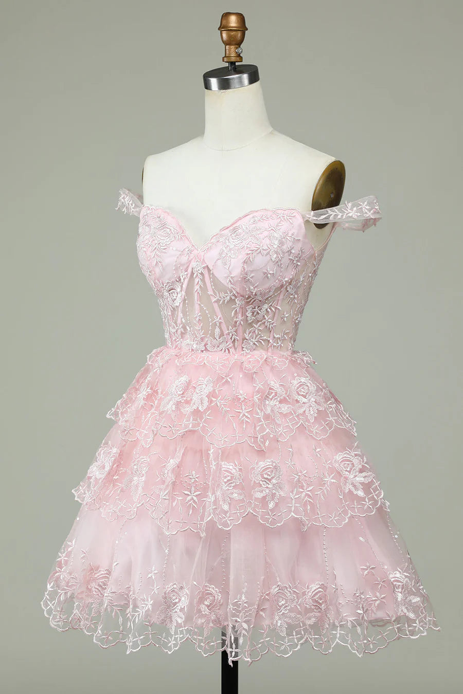 Side view of elegant off-the-shoulder applique dress.
