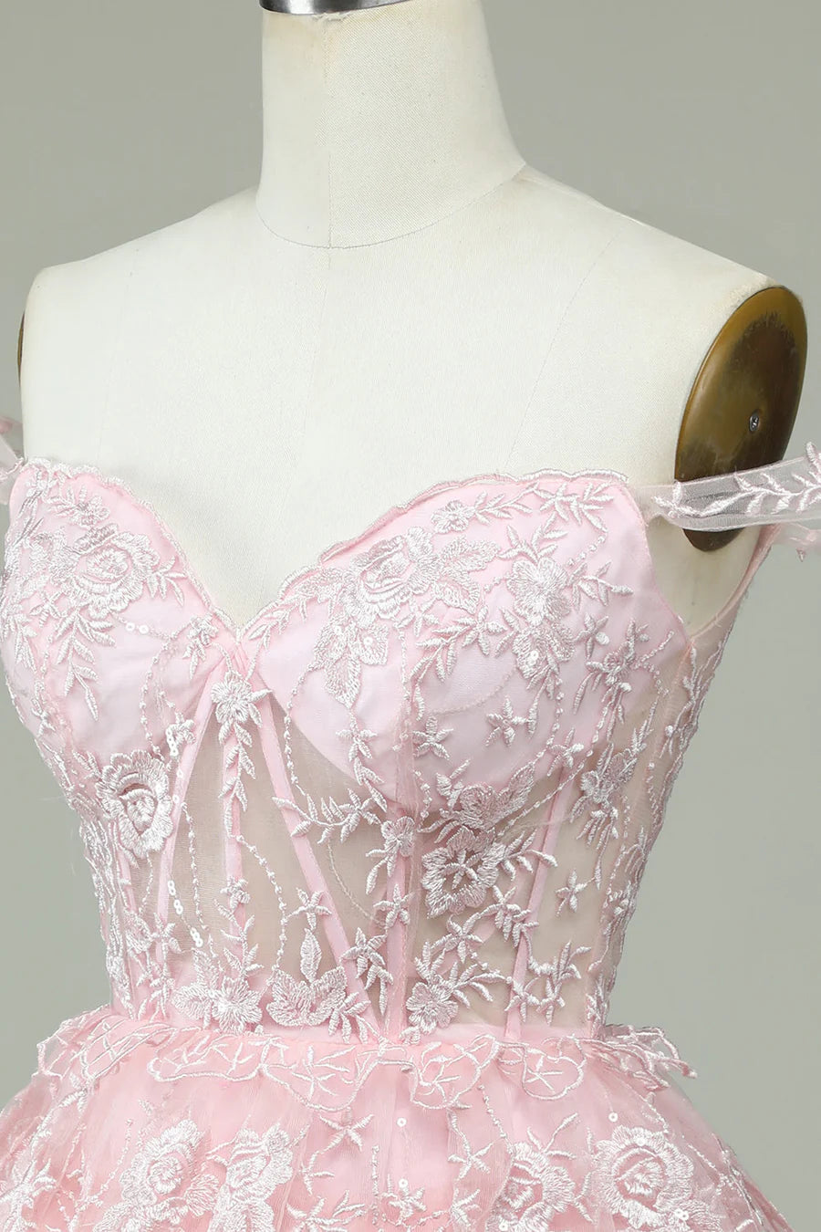 Model wearing blush pink A-line off-the-shoulder dress.