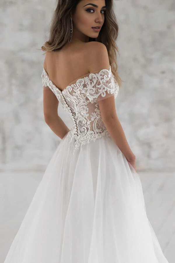 Close-up of delicate appliques on the bodice and sleeves of the wedding gown.