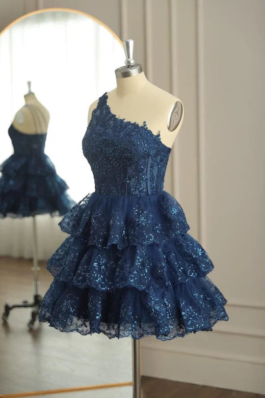 Elegant A-line one-shoulder homecoming dress with appliques and multi-layer tulle.