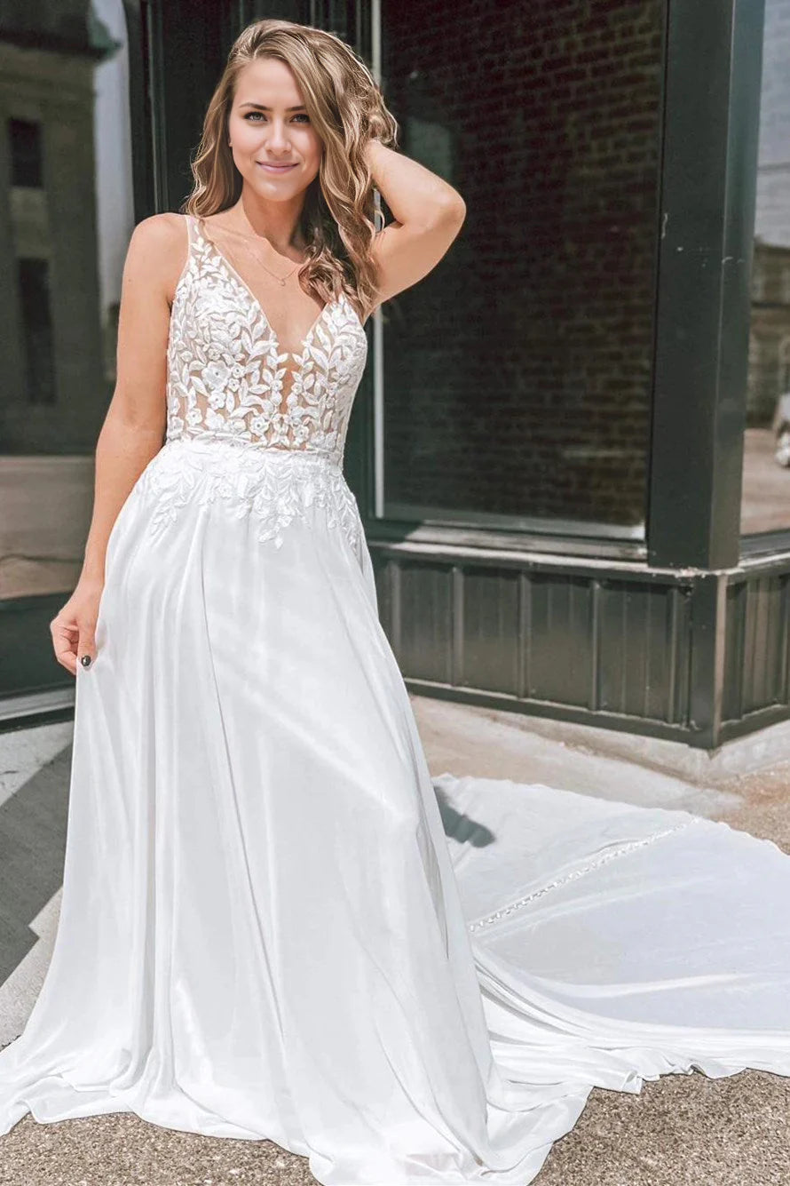 Elegant A-line wedding dress with plunge V-neck and intricate appliques.