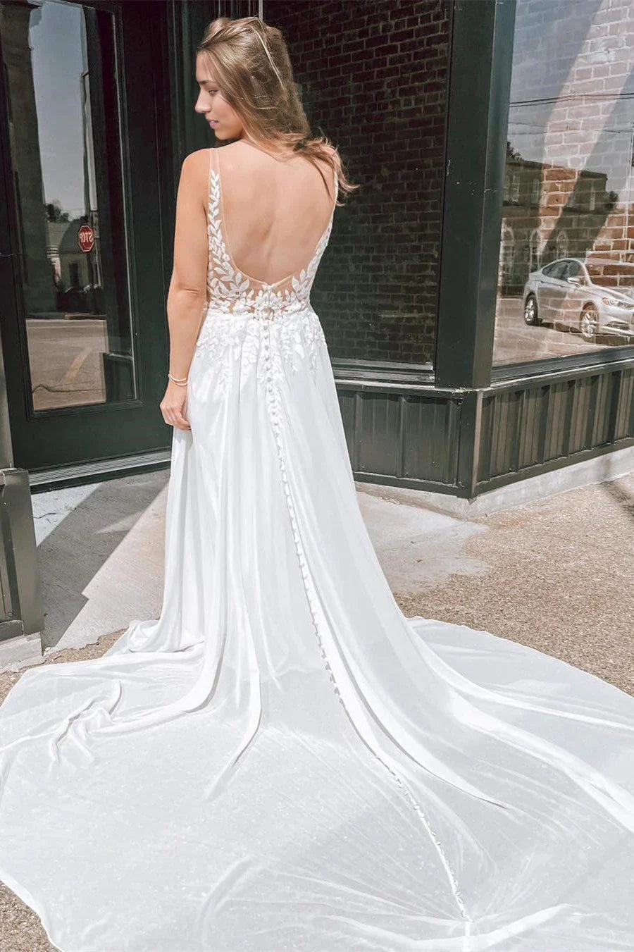 Back view of A-line wedding gown showing open back design.
