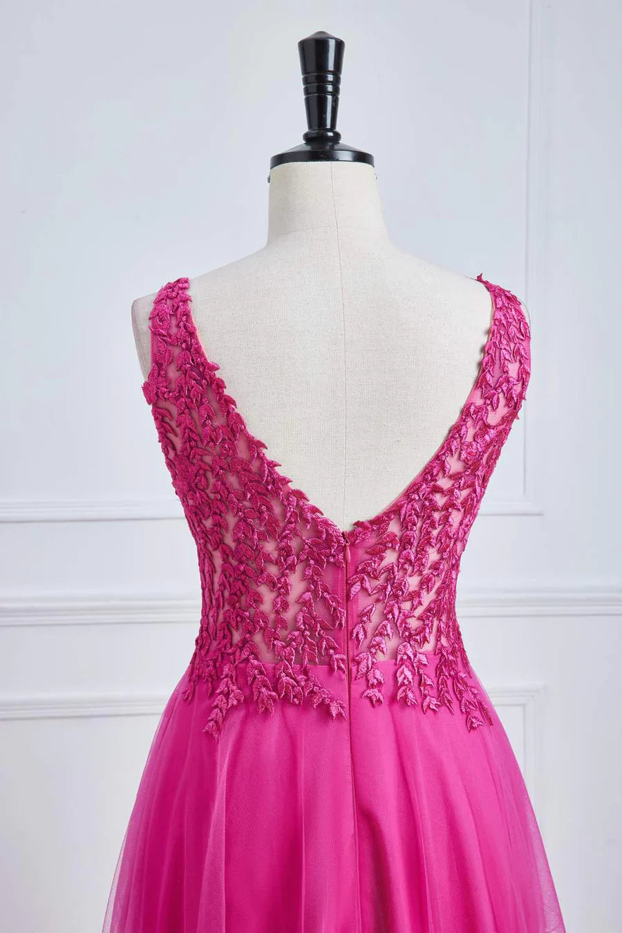 Close-up of plunging V-neckline on fuchsia floral prom dress.