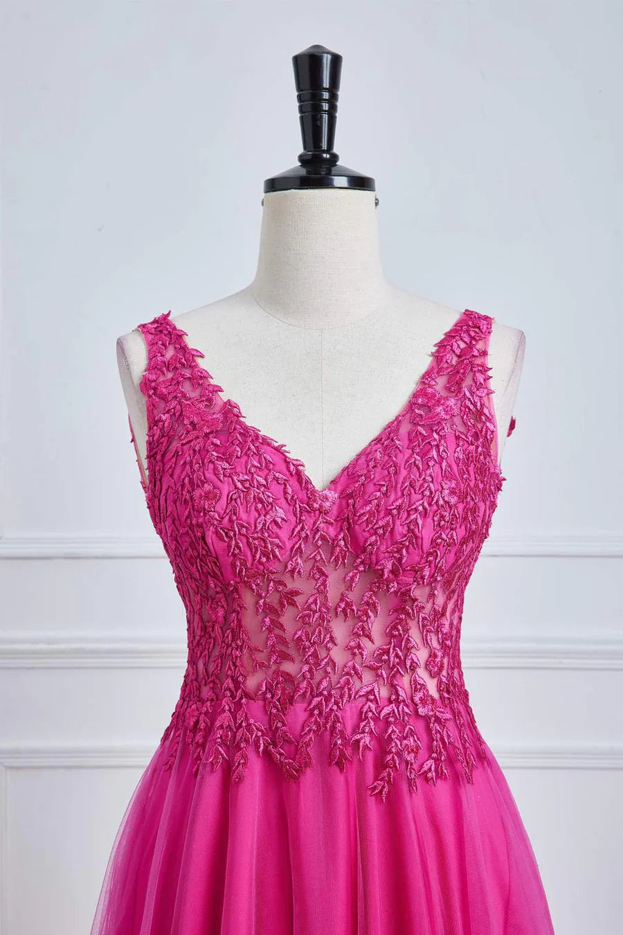 Side view of fuchsia A-line long prom dress with floral accents.