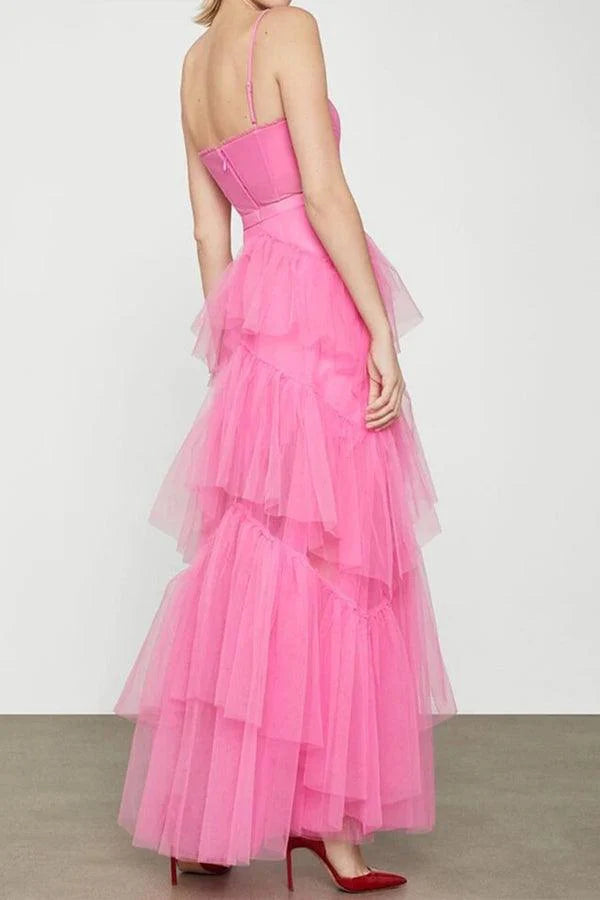 Model wearing a hot pink A-line tiered tulle long prom dress.
