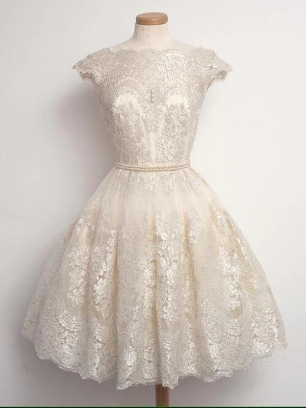 Short A-line lace dress with round neck and cap sleeves.
