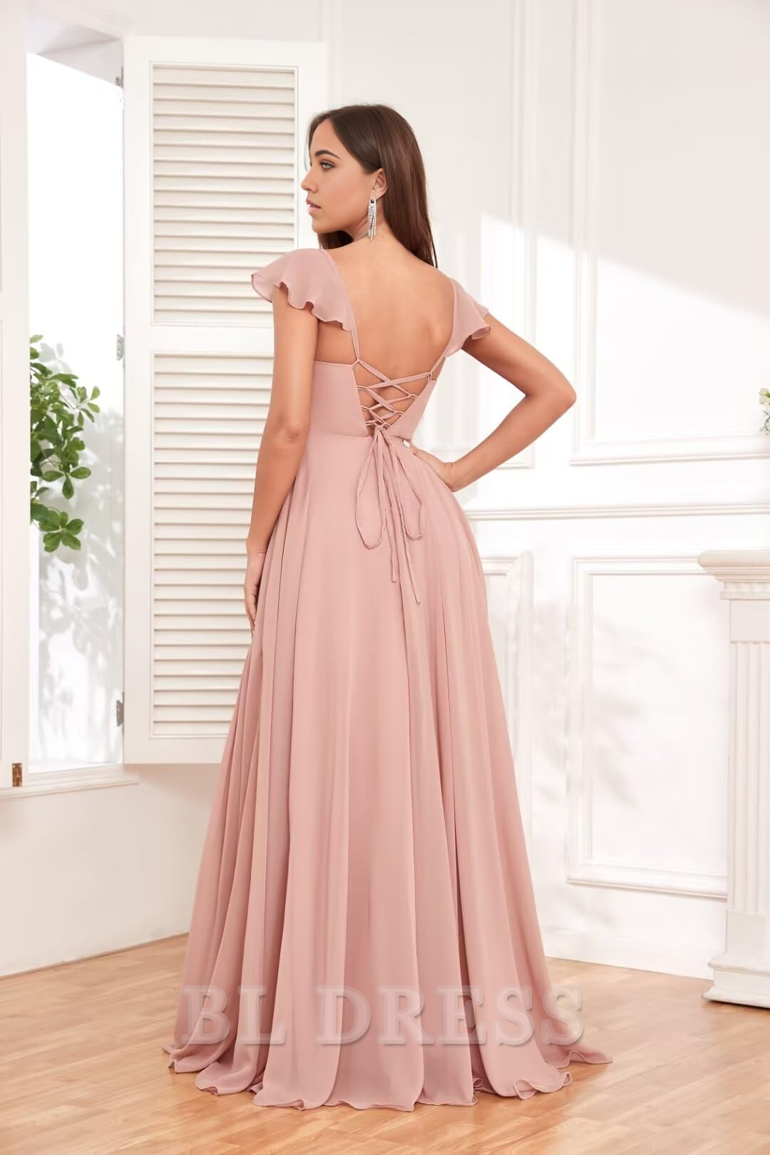 Back view of a pleated chiffon formal dress with ruffle details.