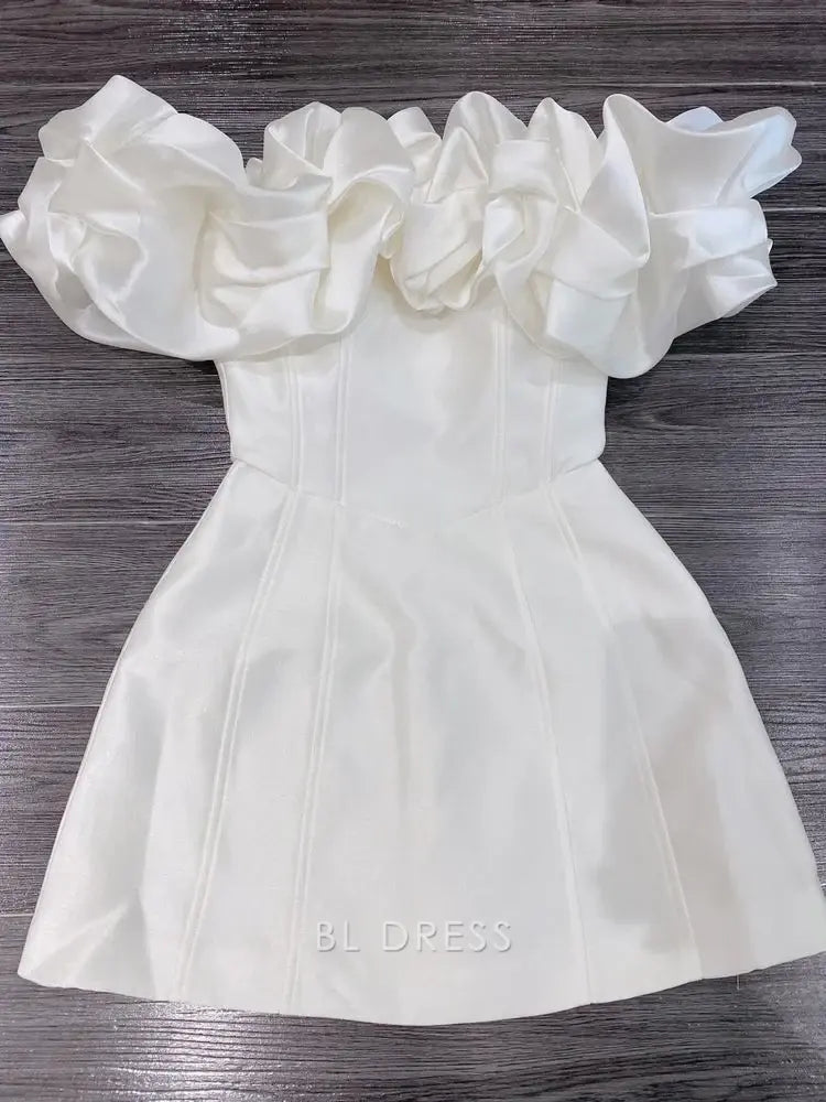 Woman wearing an elegant white A-line maxi dress with a ruffled V-neckline.