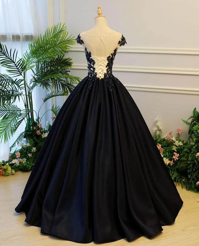 Back view of a long sleeveless satin evening gown with intricate appliques.
