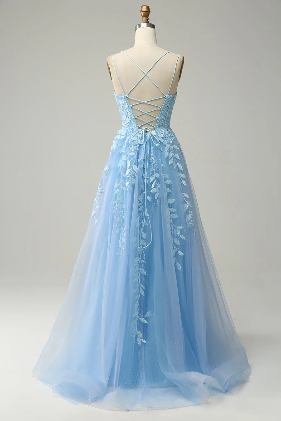 Back view of a long A-line tulle prom dress with delicate embroidery.