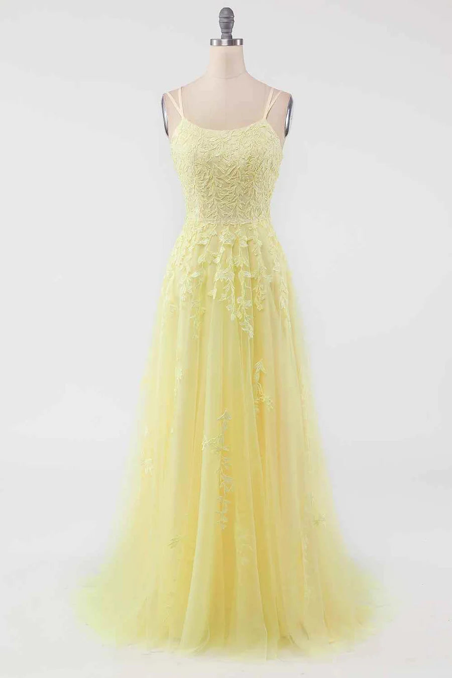Close-up of the embroidered details on the tulle fabric of the prom dress.