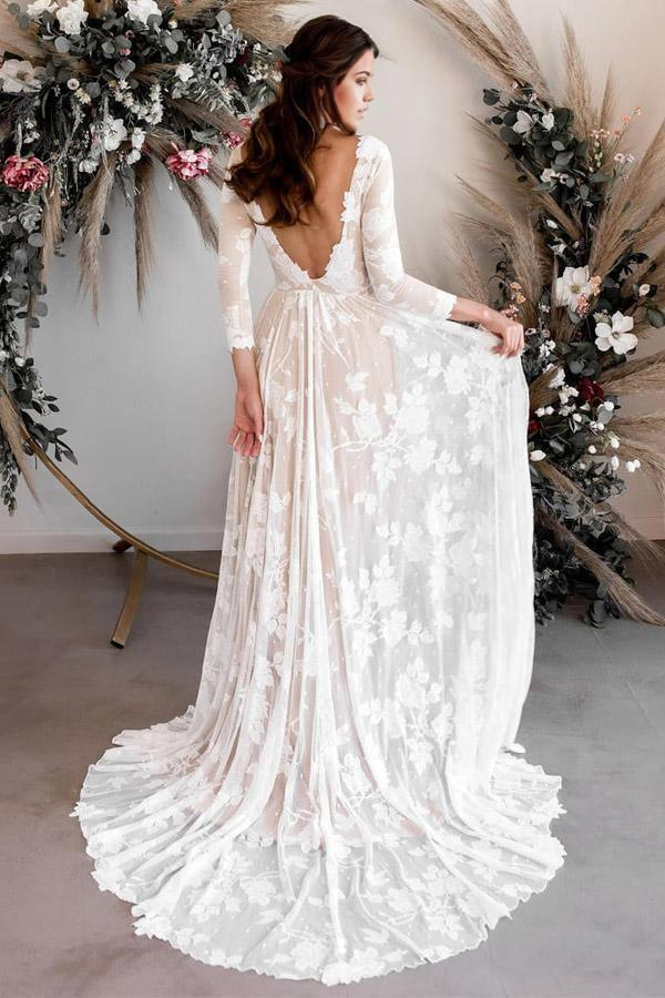 Full view of a beautiful A-line bridal gown with long lace sleeves.