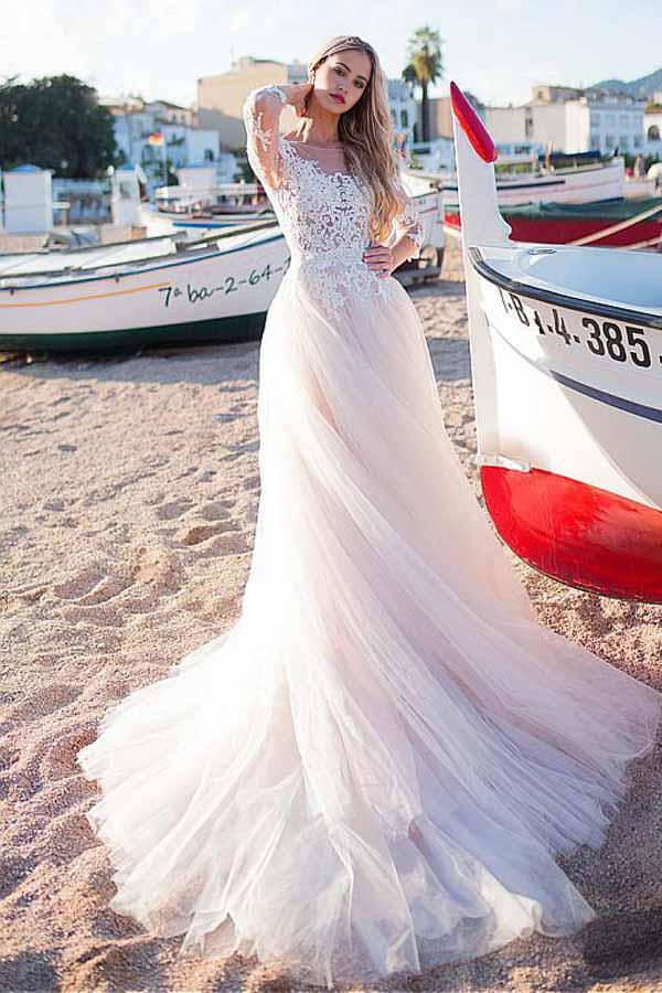 Elegant A-line wedding dress with scoop neckline, lace appliques, and flowing tulle skirt.