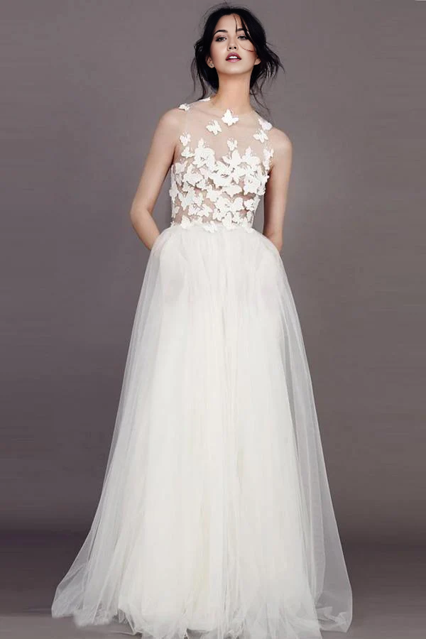 Back view of an ivory bridal gown with flowing tulle skirt.