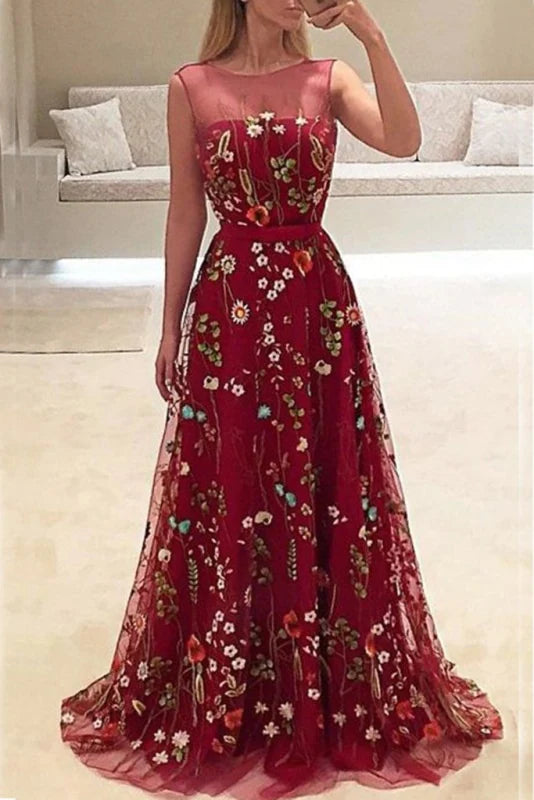 Woman wearing a dark blue A-line sleeveless long prom dress.
