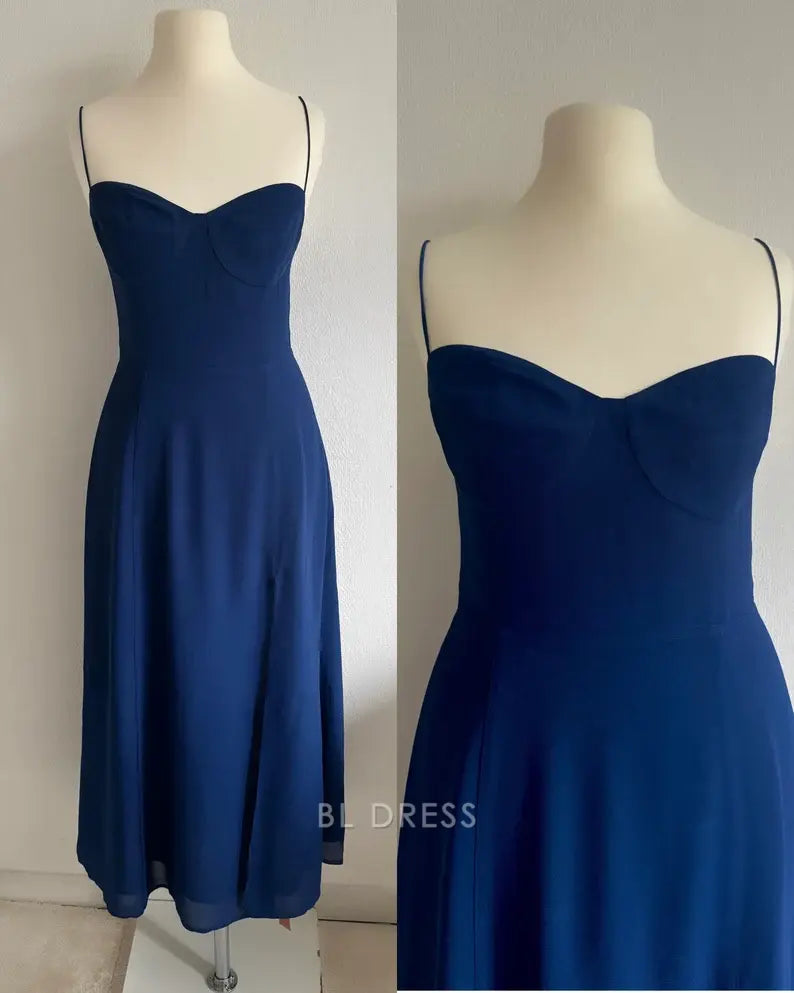 Close-up of the green A-line dress, showing spaghetti straps and elegant bodice.