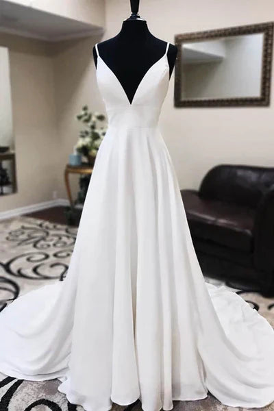 Elegant A-line wedding dress with spaghetti straps and lace appliques.