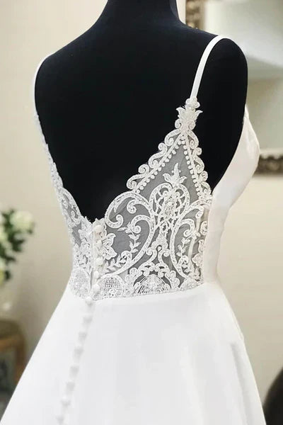 Back view of a simple A-line wedding dress with delicate lace details.