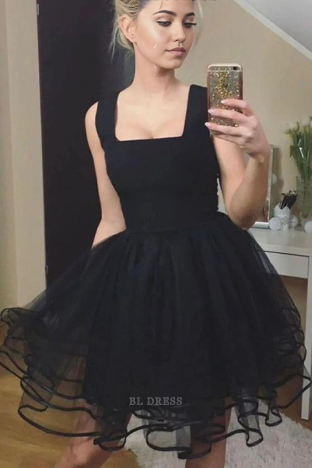 Elegant black A-line dress with a square neckline and ruffle details, perfect for formal events.