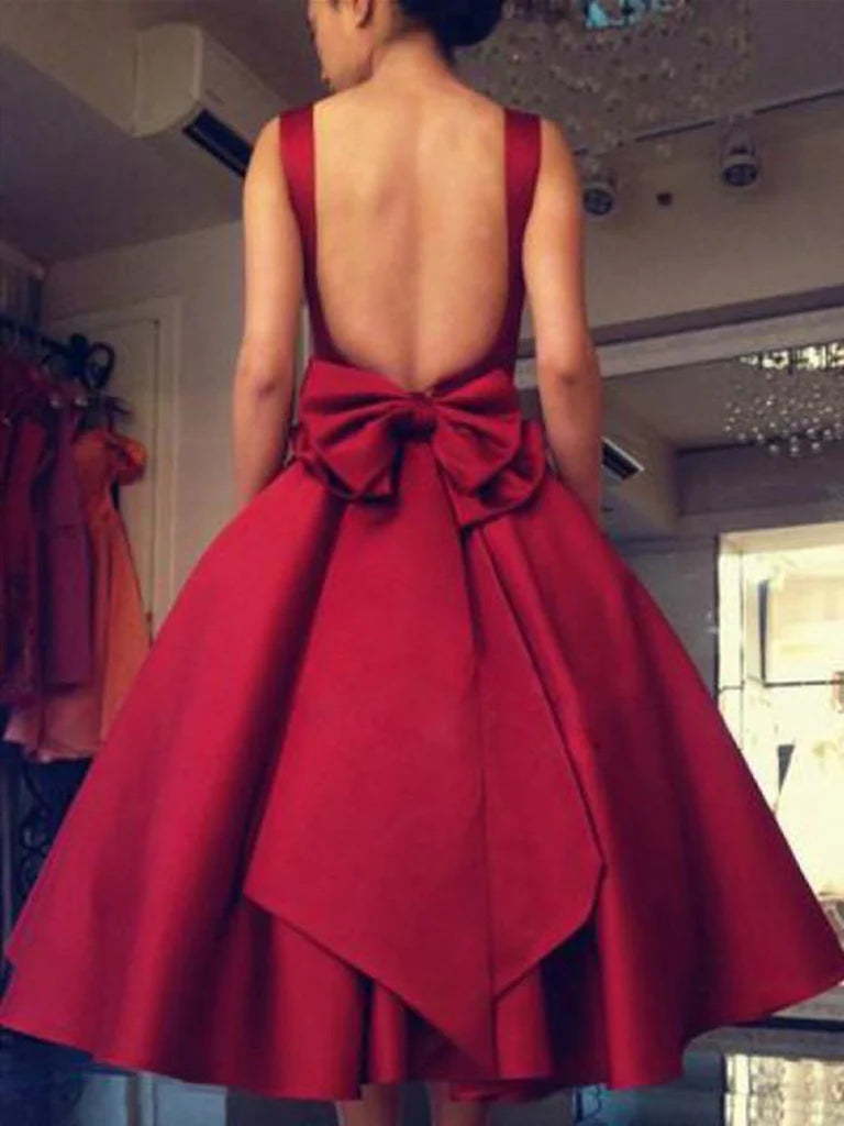 Back view of a short A-line satin dress featuring a backless design.