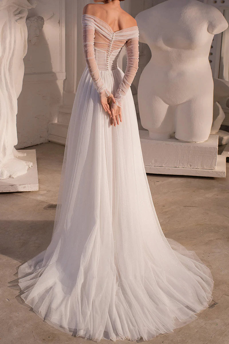 Back view of an A-line strapless wedding gown featuring a long sweep train.