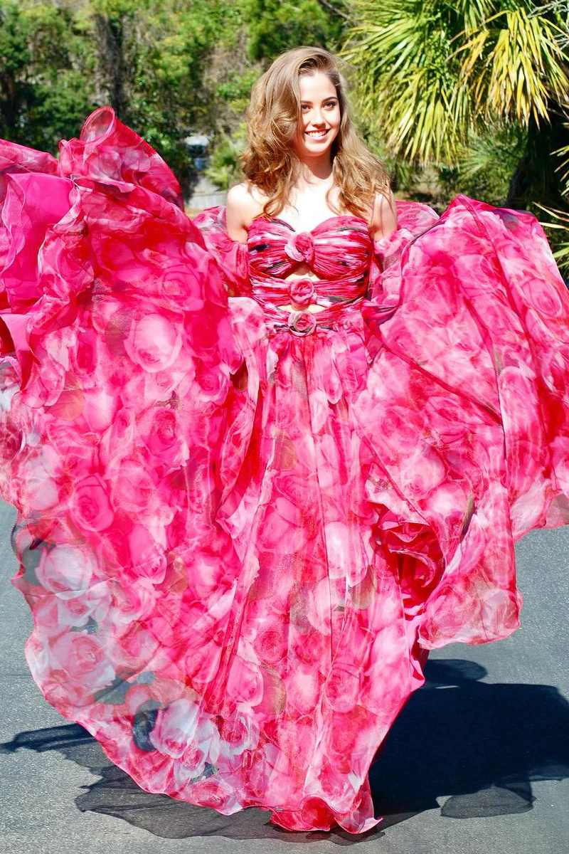 Model wearing a strapless A-line floral print long prom dress with pockets.