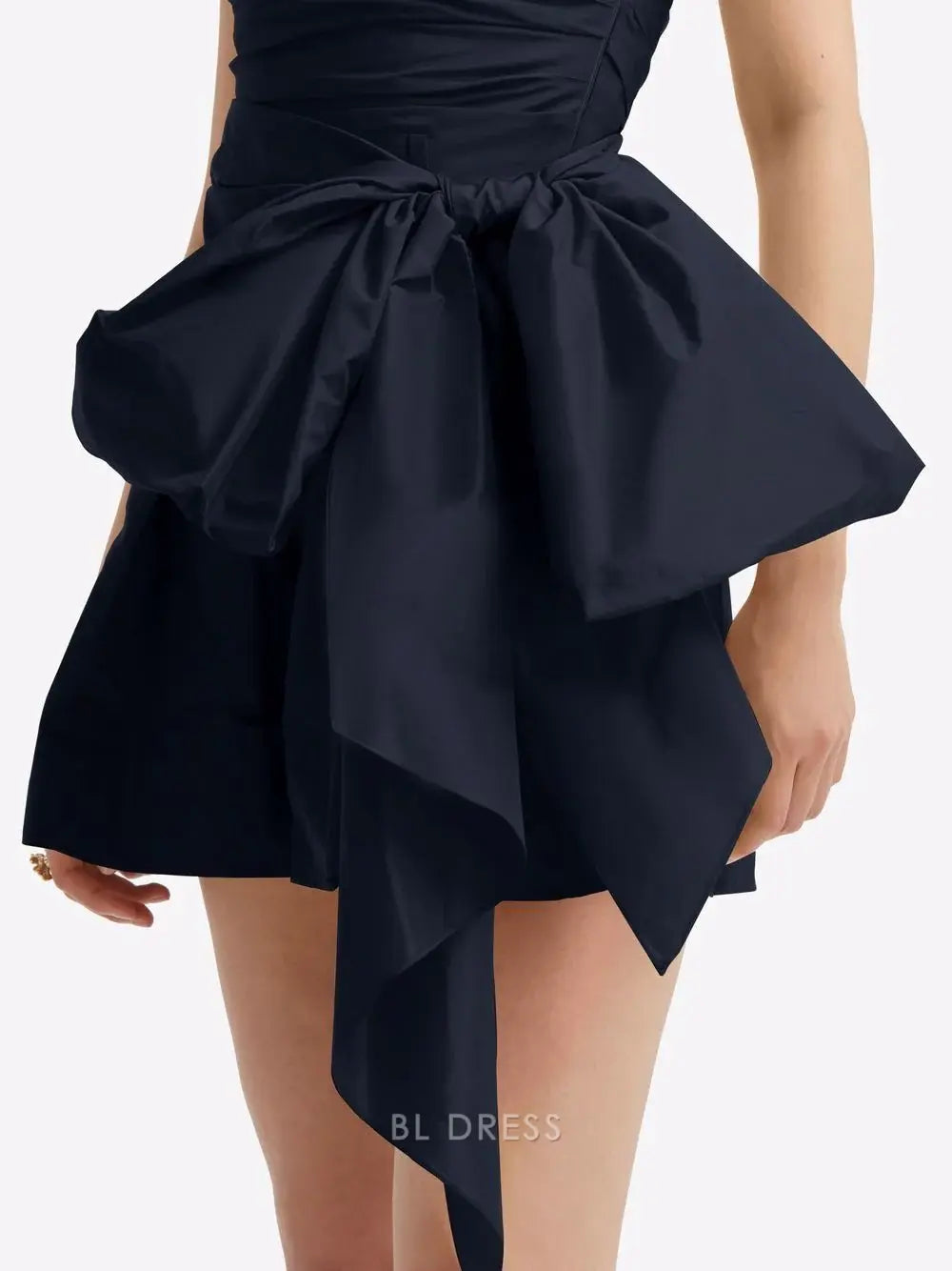 Close-up of the bodice and flowing skirt of the strapless A-line dress.