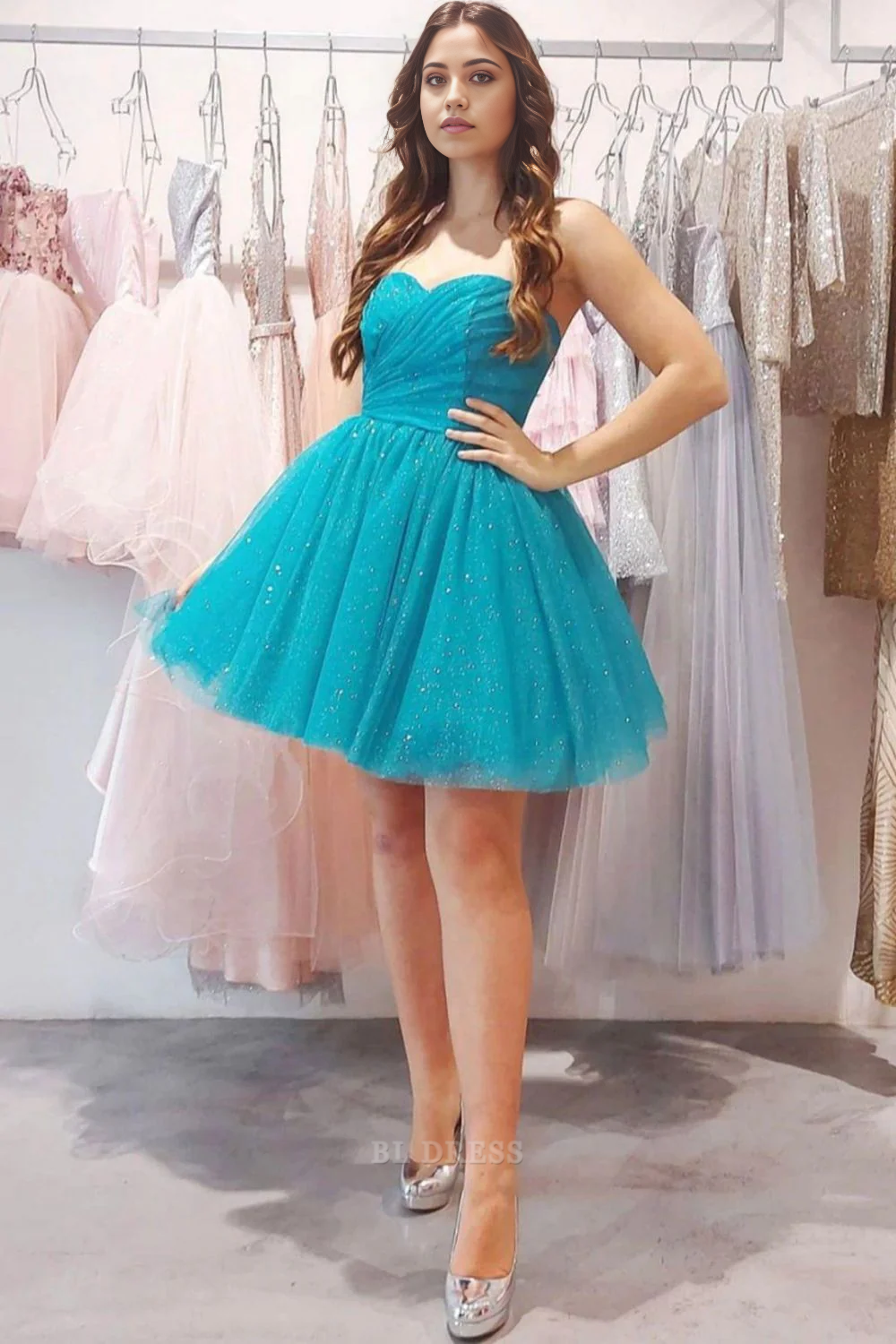 Model wearing a blue A-line strapless glitter tulle homecoming dress.