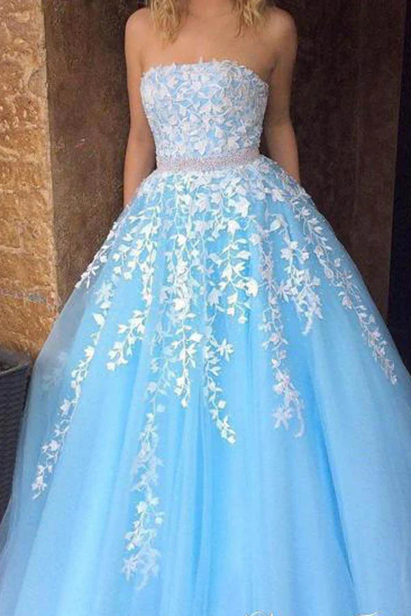 Close-up of the lace appliques on a strapless A-line tulle prom dress.