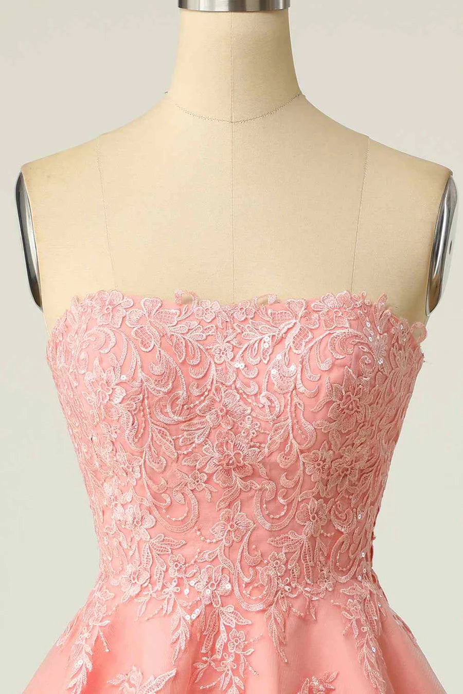 Close-up of delicate applique detail on tulle dress.