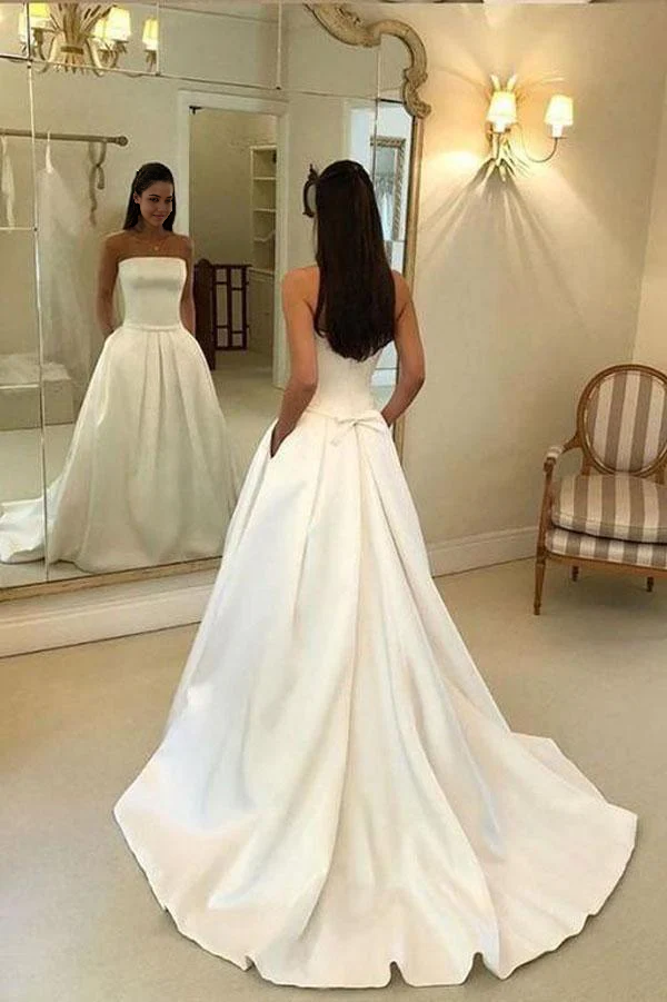 Ivory A-line strapless satin wedding dress with open back and pockets.