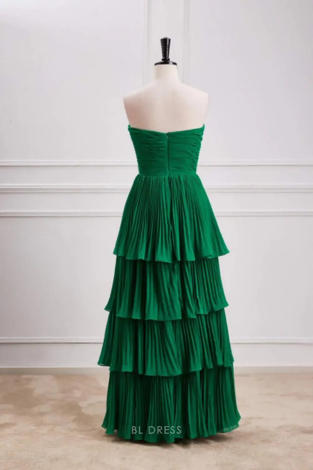 Side view of the green A-line strapless ruffle multi-layer formal dress.