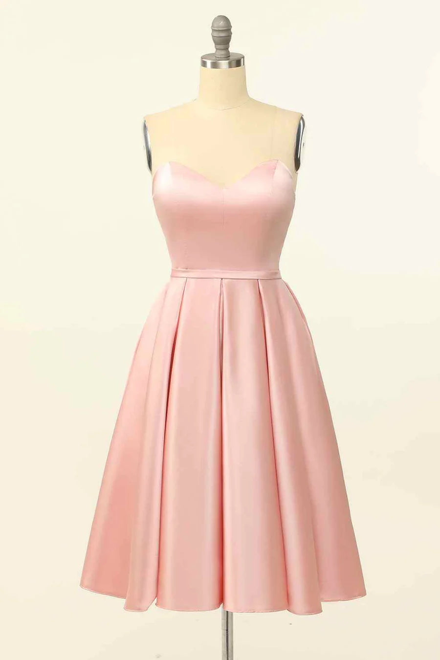 Model wearing an A-line strapless satin mini homecoming dress with a lace-up back.