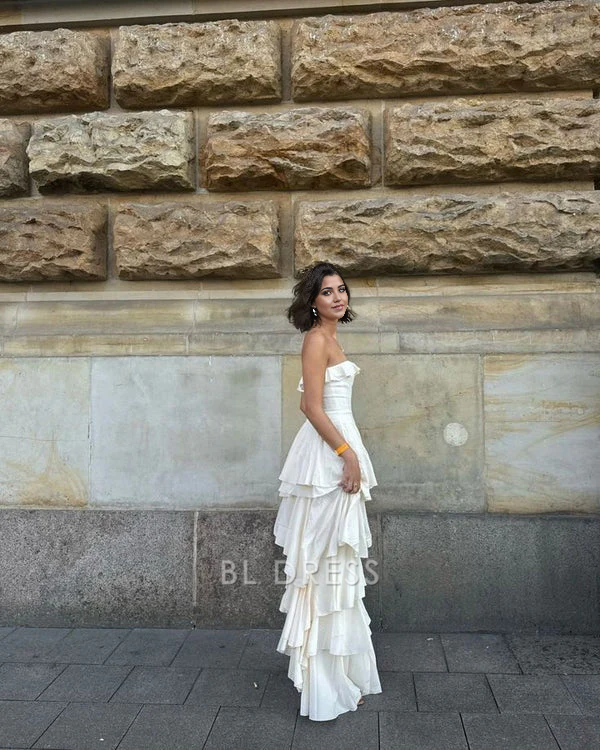 Close-up of the A-line strapless satin dress, highlighting the layered design.