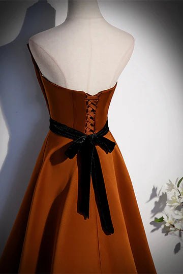 Close-up of satin fabric and ruffle detail on formal gown.