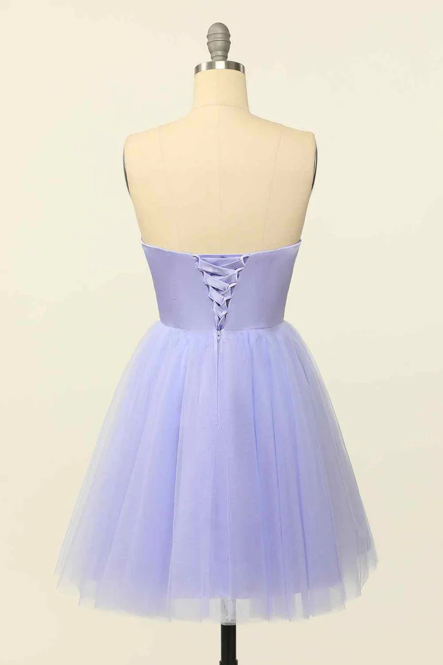 Side view of A-line mini dress showing lace-up back detail.