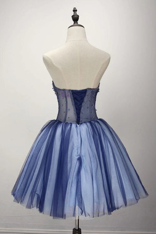 Close-up of the beaded bodice on a strapless short tulle homecoming dress.