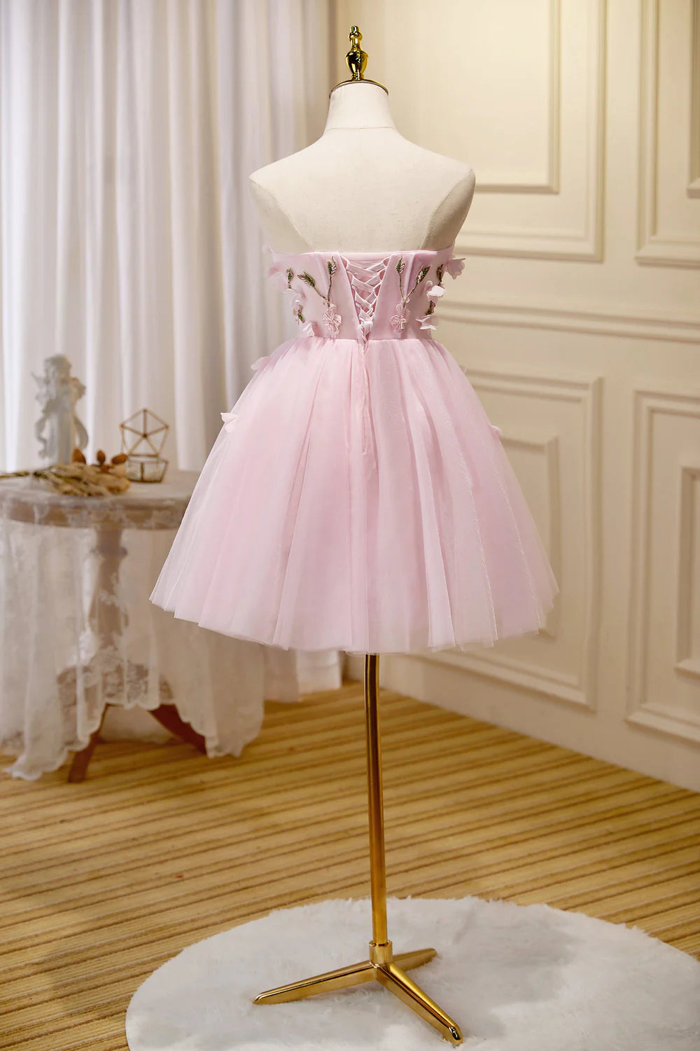 Side view of an A-line strapless tulle dress, perfect for parties.