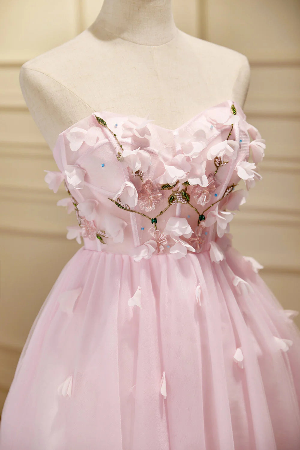 Back view of a short A-line tulle dress with a flowing skirt.
